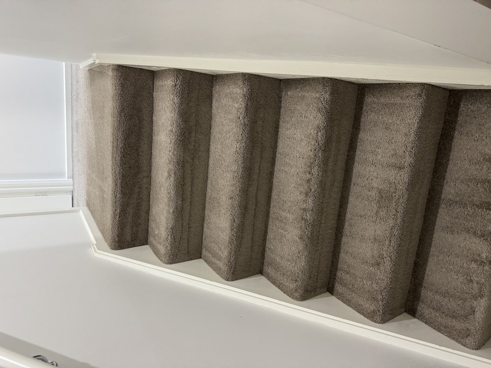 Carpeted stairs after professional carpet cleaning and steam extraction