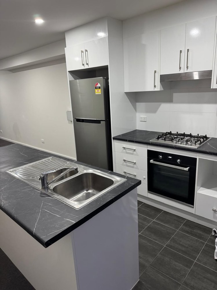Clean end of lease kitchen with polished sink and benchtops
